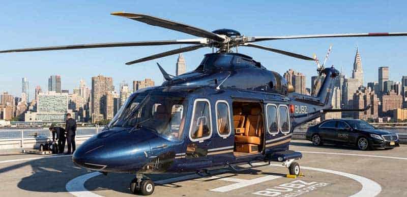 Luxury helicopter on rooftop helipad with city skyline