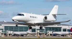 Private jet landing at airport runway