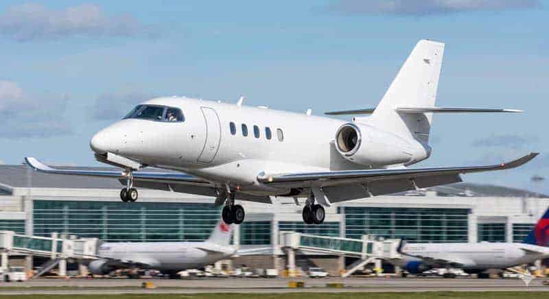 Private jet landing at airport runway