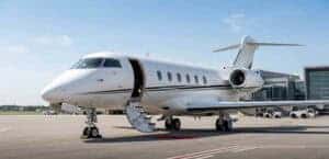 Private jet parked on runway with stairs down