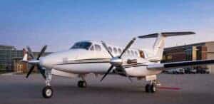White twin-engine turboprop airplane on airport tarmac