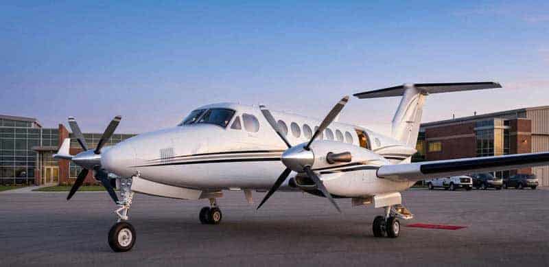 White twin-engine turboprop airplane on airport tarmac