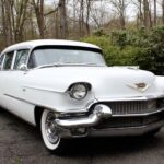 Vintage white Cadillac parked outdoors on driveway