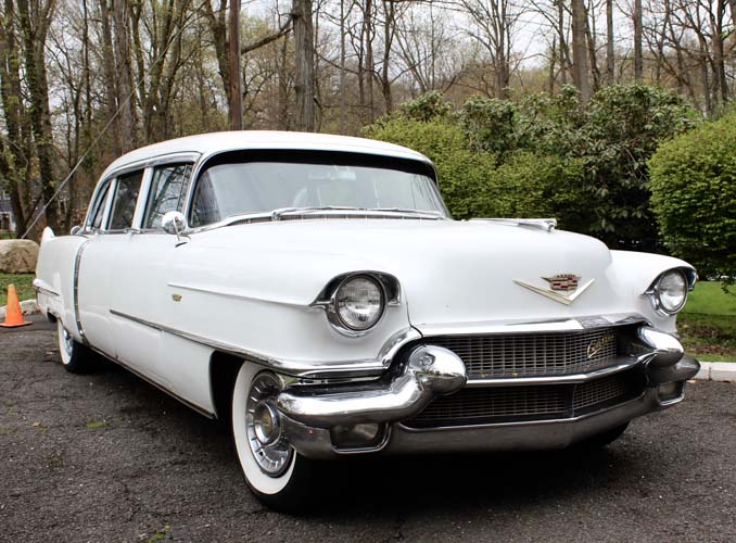 Vintage white Cadillac parked outdoors on driveway
