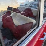 Vintage red car interior through window