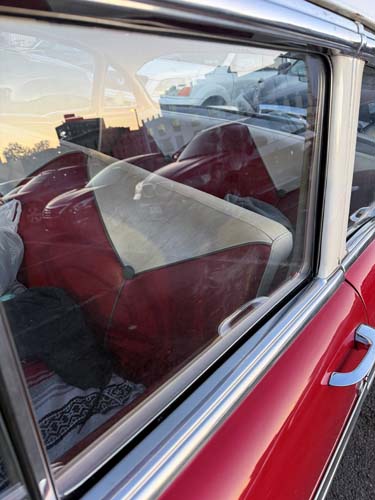 Vintage red car interior through window