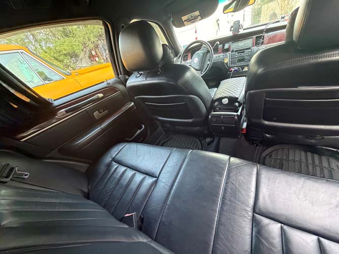 Black leather car interior with back seat view