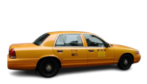 Side view of a yellow New York City taxi cab.
