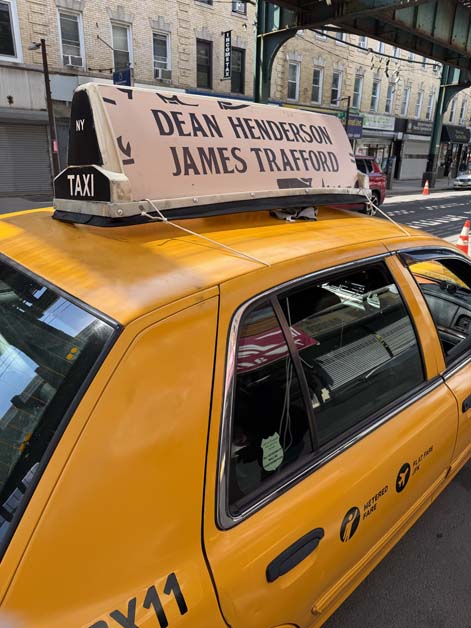 NYC taxi with 'Dean Henderson James Trafford' roof sign.
