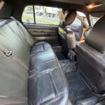 Taxi interior with black rear seats and front partition.