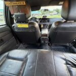 Black leather back seats of a taxi interior.