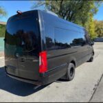 A black Mercedes-Benz Sprinter van parked outdoors.