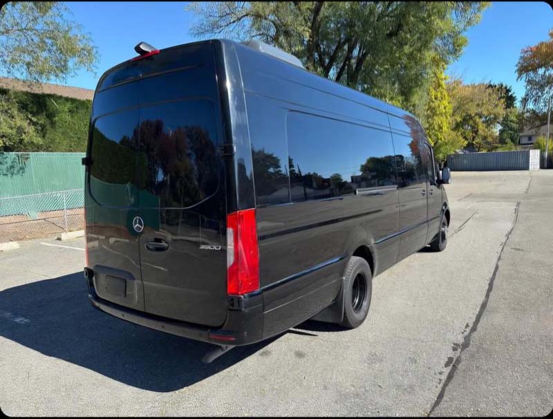 A black Mercedes-Benz Sprinter van parked outdoors.
