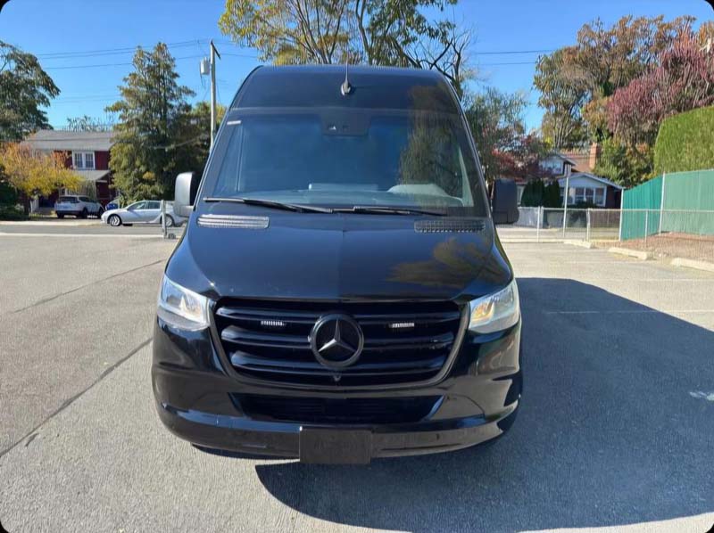 Front view of a black Mercedes-Benz Sprinter van.