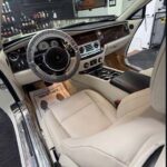 Luxurious Rolls-Royce car interior with cream leather and starlight roof.