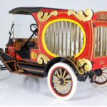 Vintage red and gold circus-themed Ford truck