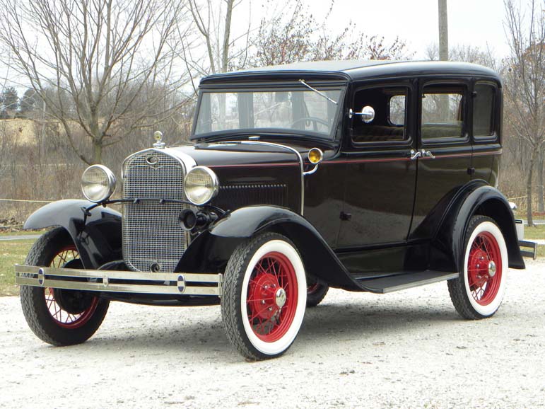 Vintage black 1930s sedan with red wheels