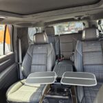 Luxury van interior with leather seats and foldout tables