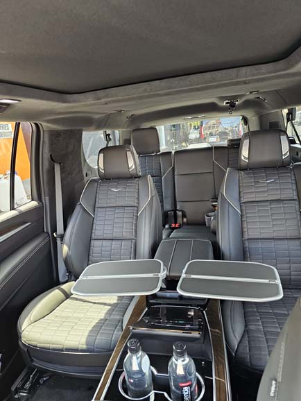 Luxury van interior with leather seats and foldout tables