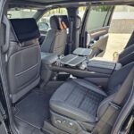 Luxury SUV interior with rear screens and tray tables