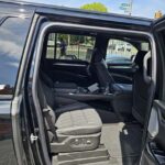 Open rear door showing black pickup truck interior