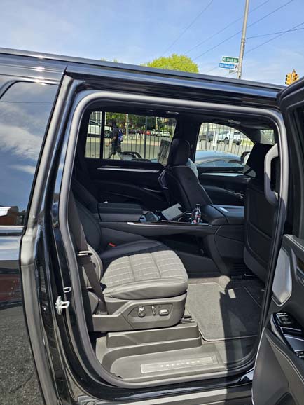 Open rear door showing black pickup truck interior