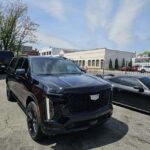Black Cadillac SUV parked in lot