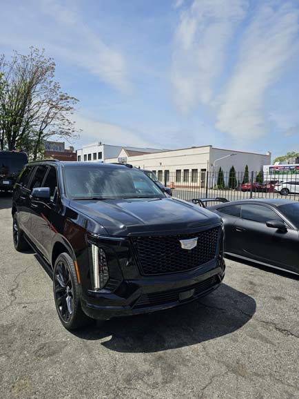 Black Cadillac SUV parked in lot