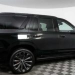 Black full-size SUV in showroom side view