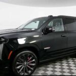 Black Cadillac Escalade SUV in showroom