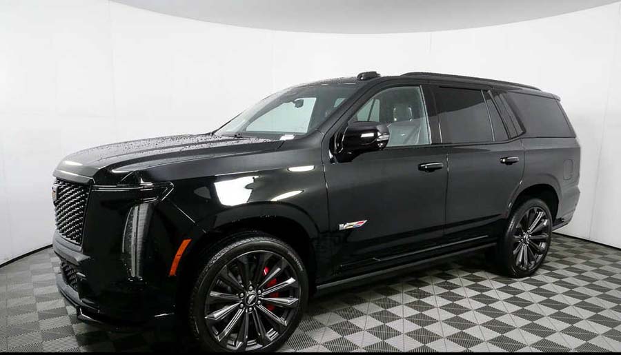 Black Cadillac Escalade SUV in showroom