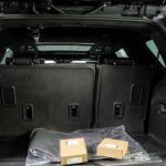 Open SUV trunk with folded seats and boxes