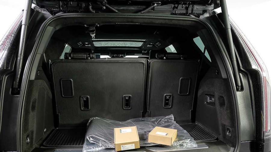 Open SUV trunk with folded seats and boxes