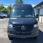 Front view of black Mercedes-Benz van parked outdoors