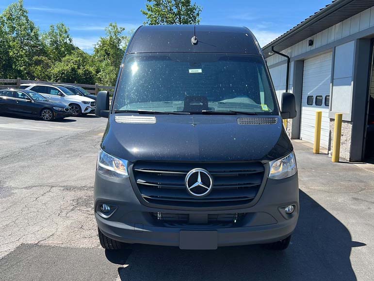 Front view of black Mercedes-Benz van parked outdoors