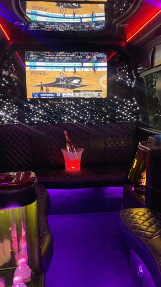 Luxury limo interior with TV and champagne