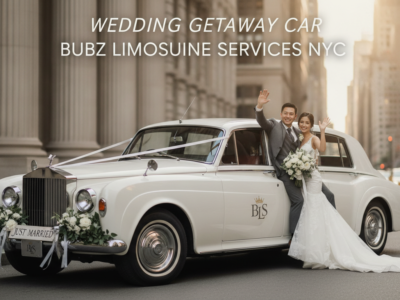 Bride and groom waving from vintage wedding car
