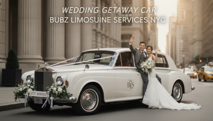 Bride and groom waving from vintage wedding car