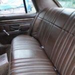 Vintage car back seat with brown leather upholstery