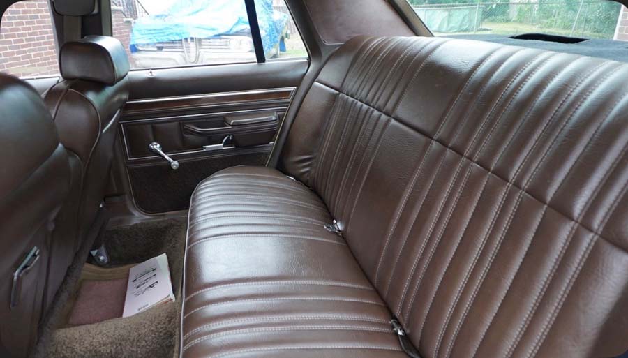 Vintage car back seat with brown leather upholstery