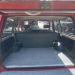 Open red SUV hatch showing carpeted cargo area