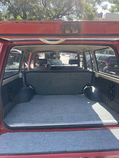 Open red SUV hatch showing carpeted cargo area