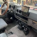 Vintage vehicle interior with manual transmission and dashboard touchscreen