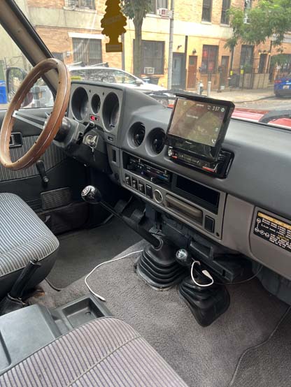 Vintage vehicle interior with manual transmission and dashboard touchscreen