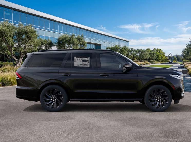 Black luxury SUV parked beside modern glass office building