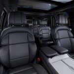 Luxury SUV interior with black leather seats and panoramic sunroof