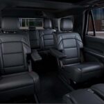 Black leather captain's chairs inside a luxury SUV