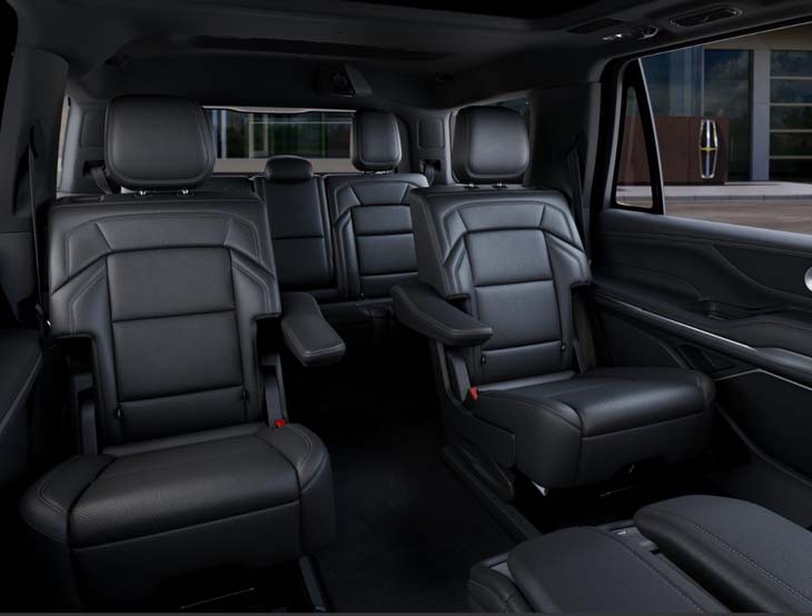 Black leather captain's chairs inside a luxury SUV