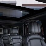 Black leather SUV interior with panoramic sunroof