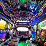 Colorful LED-lit limousine interior with leather seating